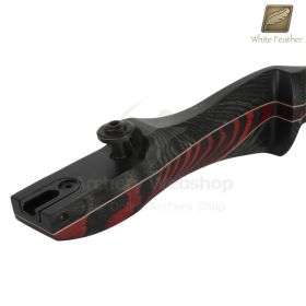 A side profile of the Firefinch riser displays the flowing lines of its wooden construction and the contrast between rich red and dark black layers. The sculpted grip area suggests comfort and control, while the limb pocket region indicates readiness for 